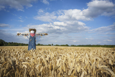Hay bales on field against sky