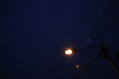 Low angle view of illuminated power lines