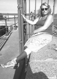 Portrait of young woman sitting outdoors