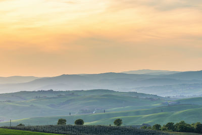 View of a valley with a rolling landscape at sunset