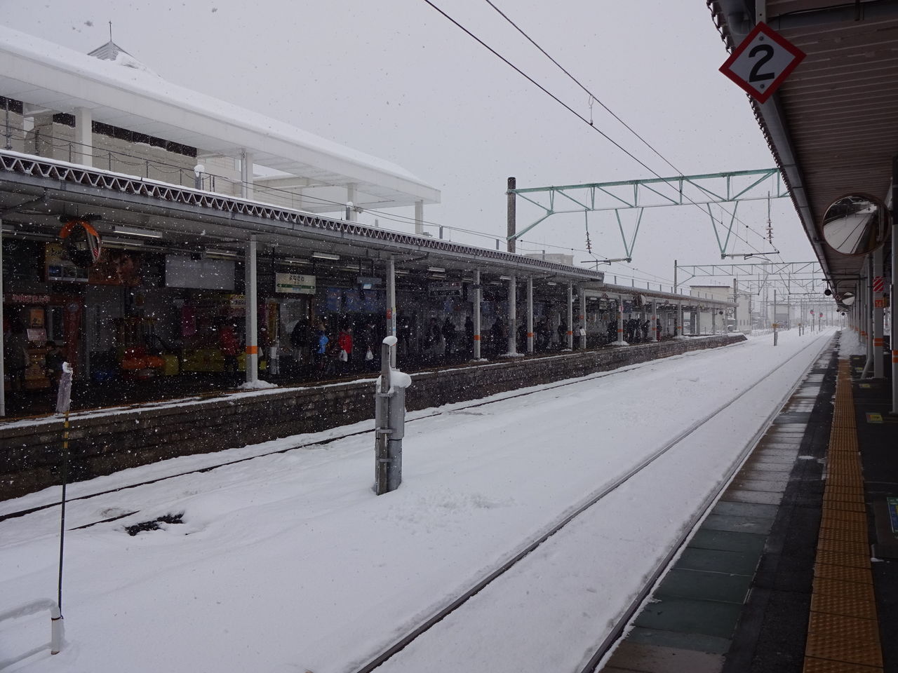 TRAIN AT RAILROAD STATION AGAINST SKY