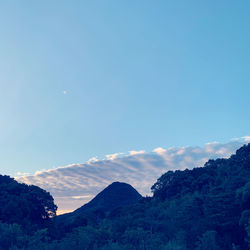 Low angle view of mountains against blue sky