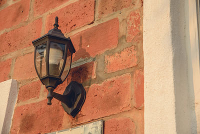 Low angle view of lantern on wall