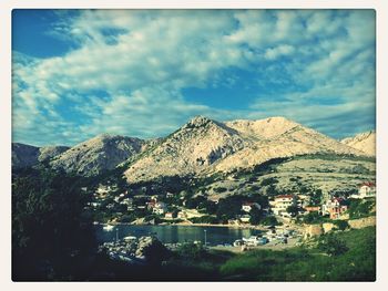 Scenic view of mountains against cloudy sky