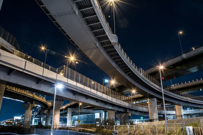 Low angle view of illuminated bridge against sky at night