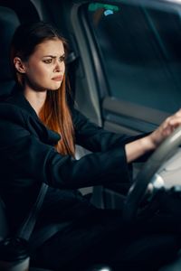 Sad woman sitting in car