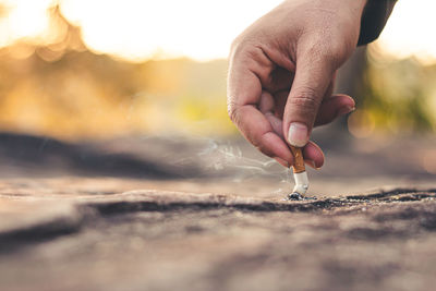 Close-up of person holding cigarette