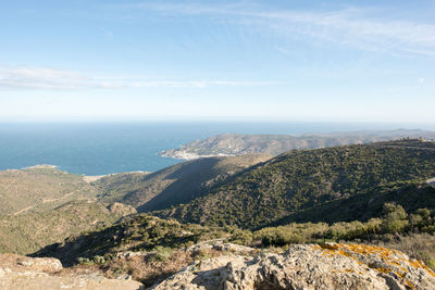 Scenic view of sea and mountains against sky