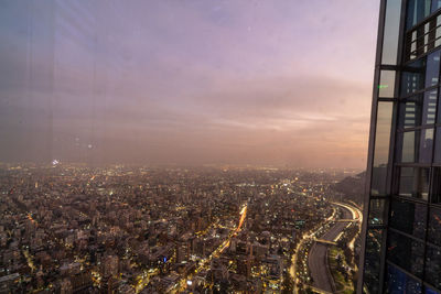 High angle view of illuminated cityscape against sky during sunset