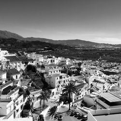 High angle view of houses in town against clear sky