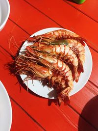 High angle view of red chili peppers in plate on table