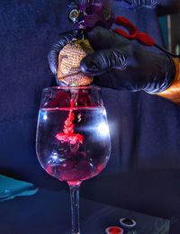 Midsection of man pouring wine in glass