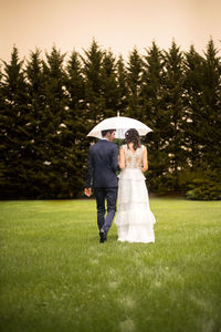 Woman with umbrella on grass