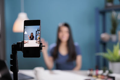 Low angle view of woman using mobile phone