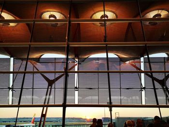 Low angle view of illuminated pendant lights hanging from ceiling