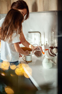 Midsection of woman having food at home