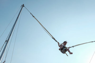 Low angle view of crane against sky