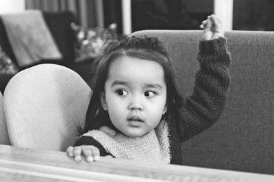 Portrait of cute girl lying on sofa