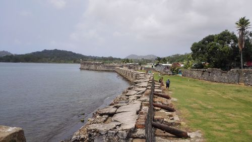 High angle view of cannons by lake against sky