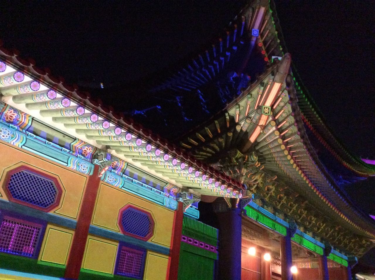 illuminated, night, architecture, low angle view, built structure, multi colored, building exterior, lighting equipment, arts culture and entertainment, roof, pattern, blue, outdoors, architectural feature, cultures, no people, famous place, travel destinations, culture, ceiling