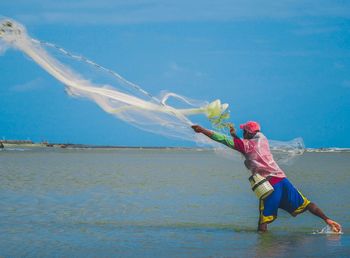 Full length of woman on beach against sky