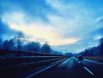 Road passing through dramatic sky