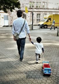Rear view of woman walking on street