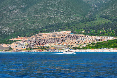 Scenic view of sea against buildings