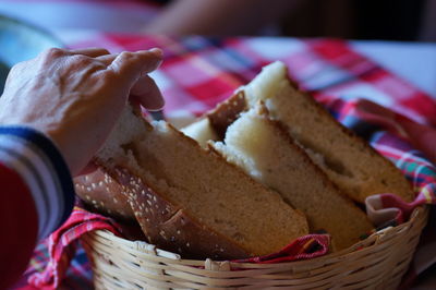 Close-up of hand holding ice cream in basket