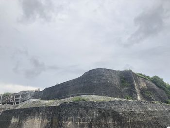 Low angle view of rock formations against sky