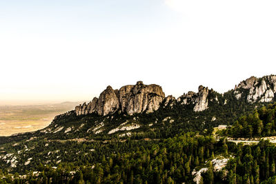 Scenic view of rocky mountains against clear sky