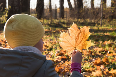 Rear view of person on autumn leaves