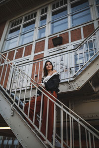 Woman climbing on steps of building