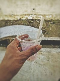 Close-up of hand holding ice cream cone