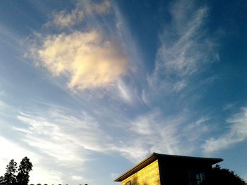 Low angle view of silhouette building against sky