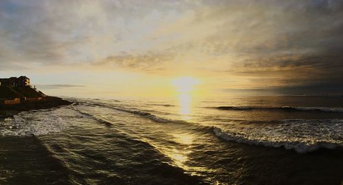 Scenic view of beach against sky during sunset