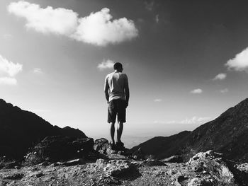 Rear view of man standing on mountain