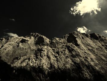 Low angle view of cliff against sky