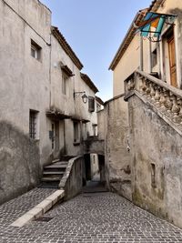 Cobbled alley amidst buildings in village