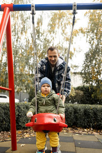 Boy swinging at playground