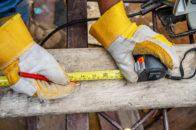 Close-up of yellow working on wood