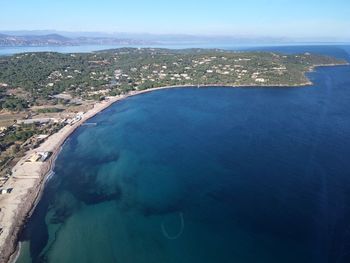 Aerial view of sea against blue sky