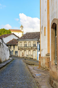 Street amidst buildings against sky