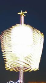 Low angle view of illuminated lights at night