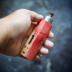 Close-up of cropped hand holding electronic cigarette