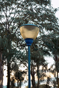 Low angle view of street light against blue sky