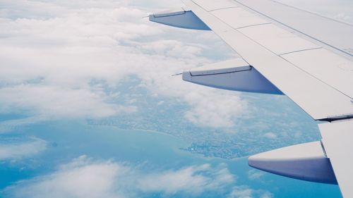 Aerial and airplane wing view  of airplane flying in nice sky.