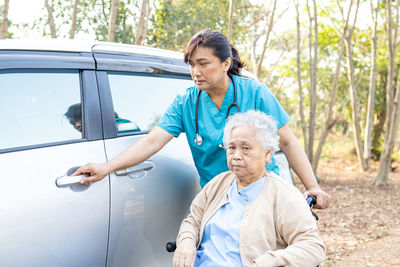 Full length of woman standing on car