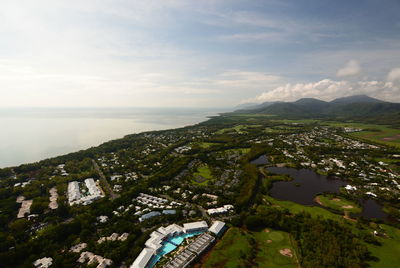 High angle view of buildings by sea against sky