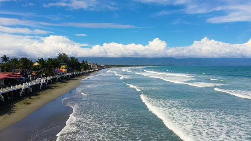 The city of baler in the philippines, known as the capital of surfing. wide beach with big waves